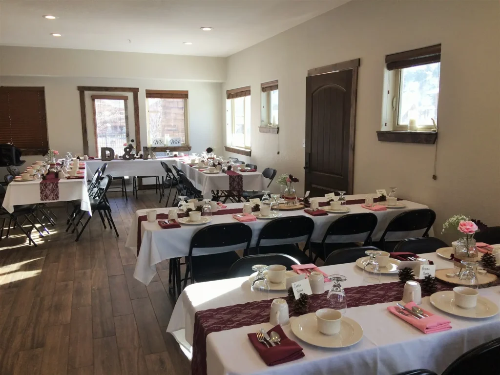 A dining room hall set for a wedding dinner.