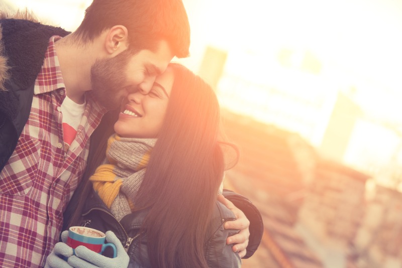 A young couple share an embrace as they enjoy their Estes Park romantic getaway.