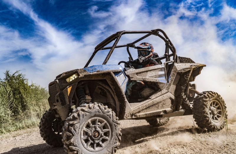 Estes Park ATV Rental: An power sports enthusiast rides an ATV on a mountain road near Estes Park.